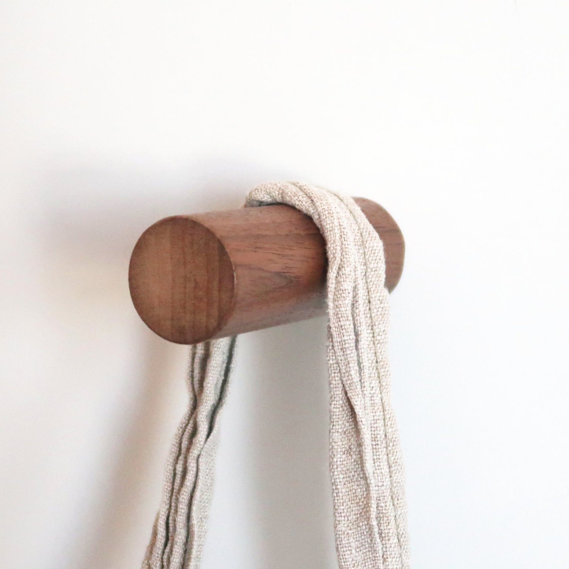 Solid walnut wall hook with a hanging bag